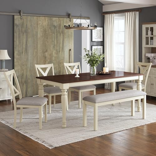 farmhouse dining room scene with the rustic white table set, four chairs and bench under a pendant light