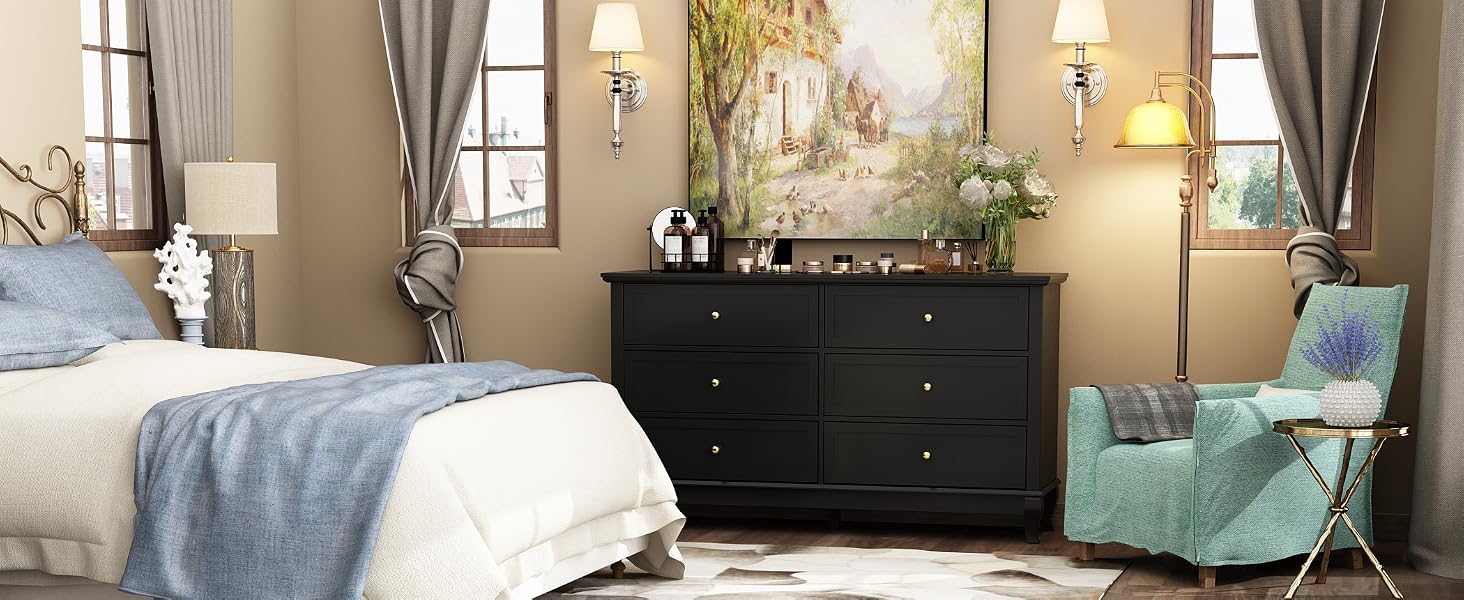 black dresser with metal handles in a bedroom